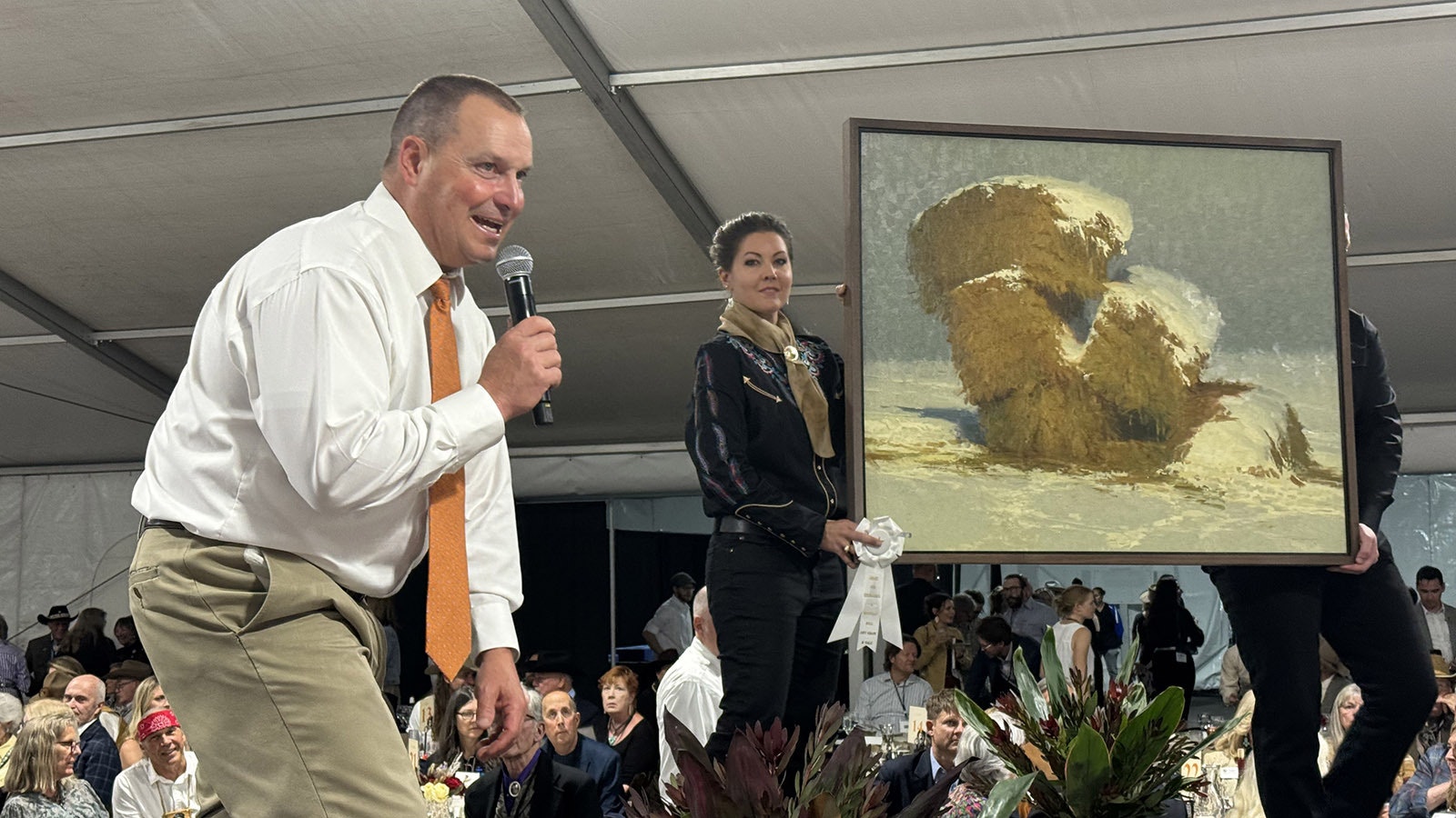 Auctioneer Troy Black goads a patron into taking another look (and making another bid) at 