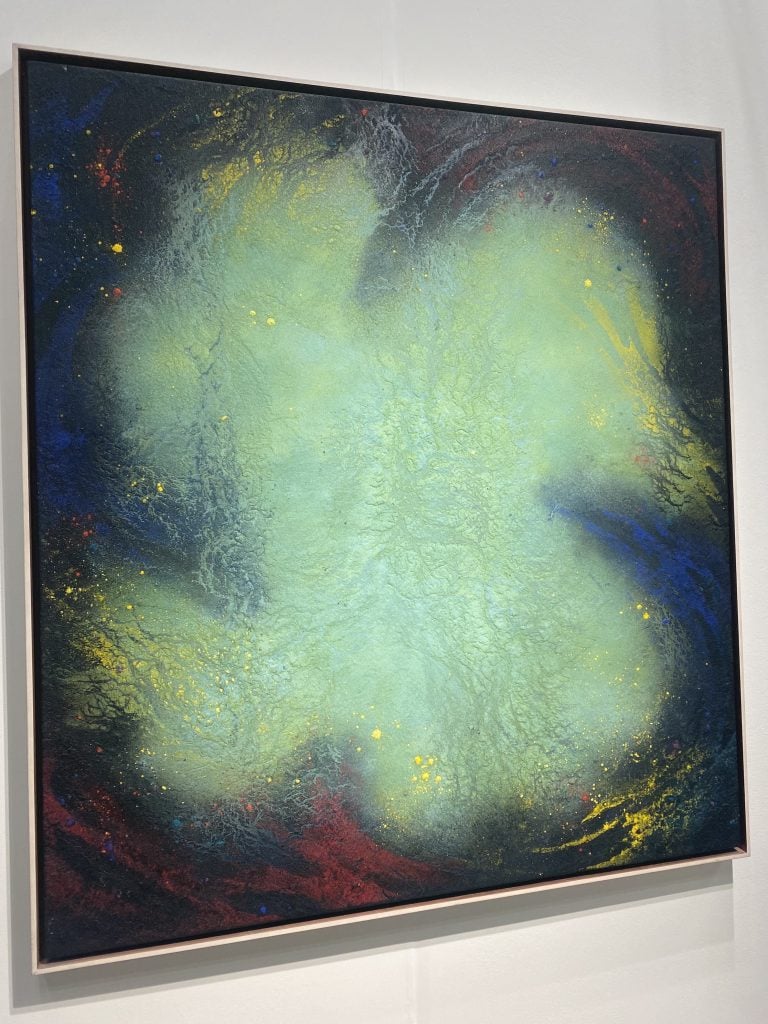 an image of a painting with a light green splash on a dark background