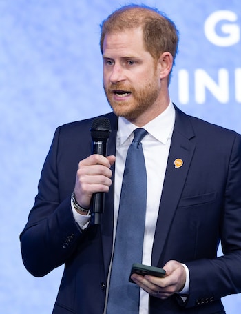 Prince Harry with his phone out