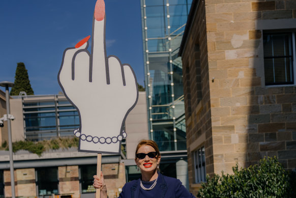 Kaechele holds up a placard after the verdict was handed down on Friday.