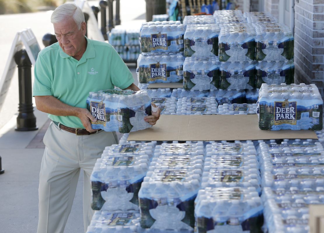 Larry Pierson, from the Isle of Palms, S.C., purchases bottled water from the Harris Teeter grocery store on the Isle of Palms in preparation for Hurricane Florence at the Isle of Palms S.C., Monday, Sept. 10, 2018. (AP Photo/Mic Smith)