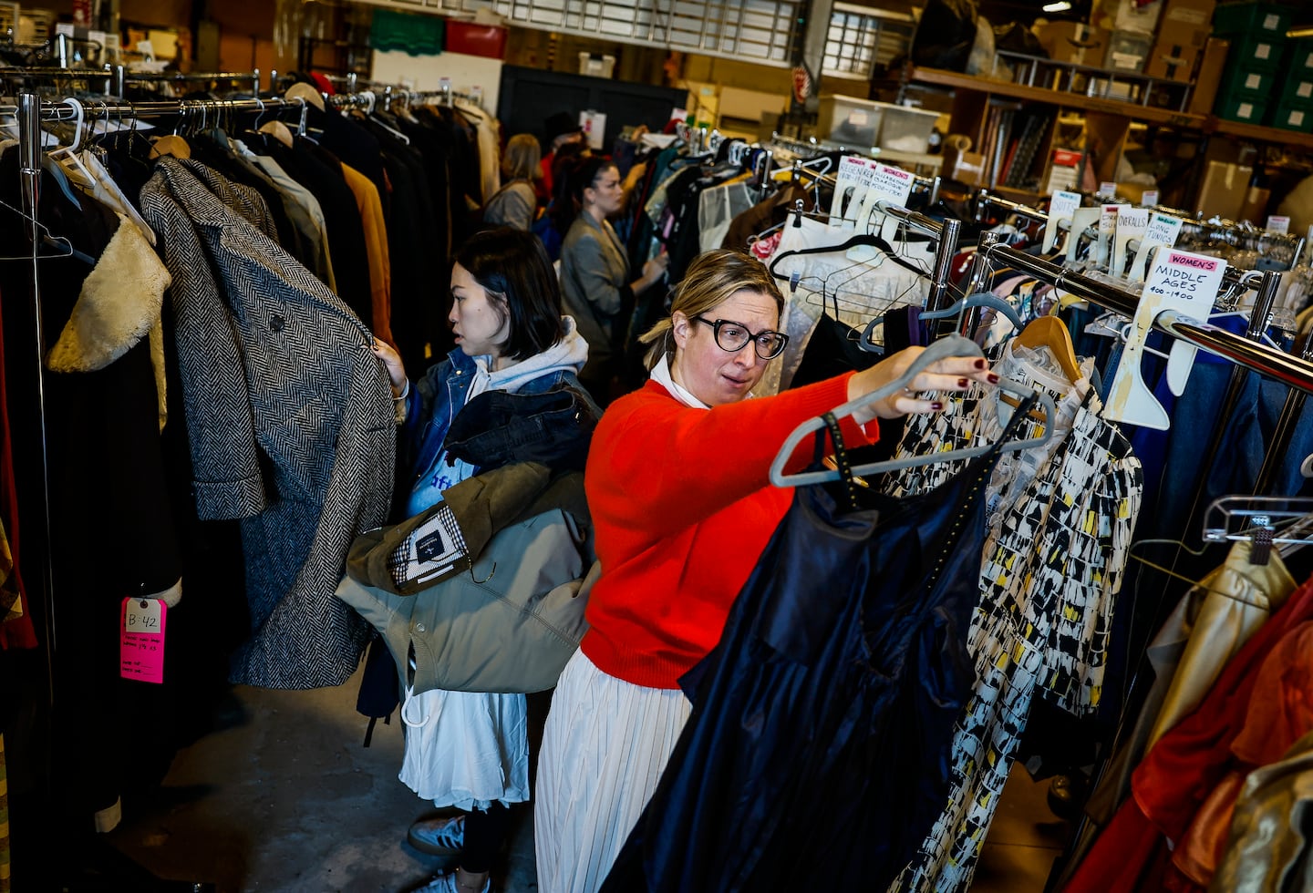 People browse costumes at the American Repertory Theater's sale Friday.