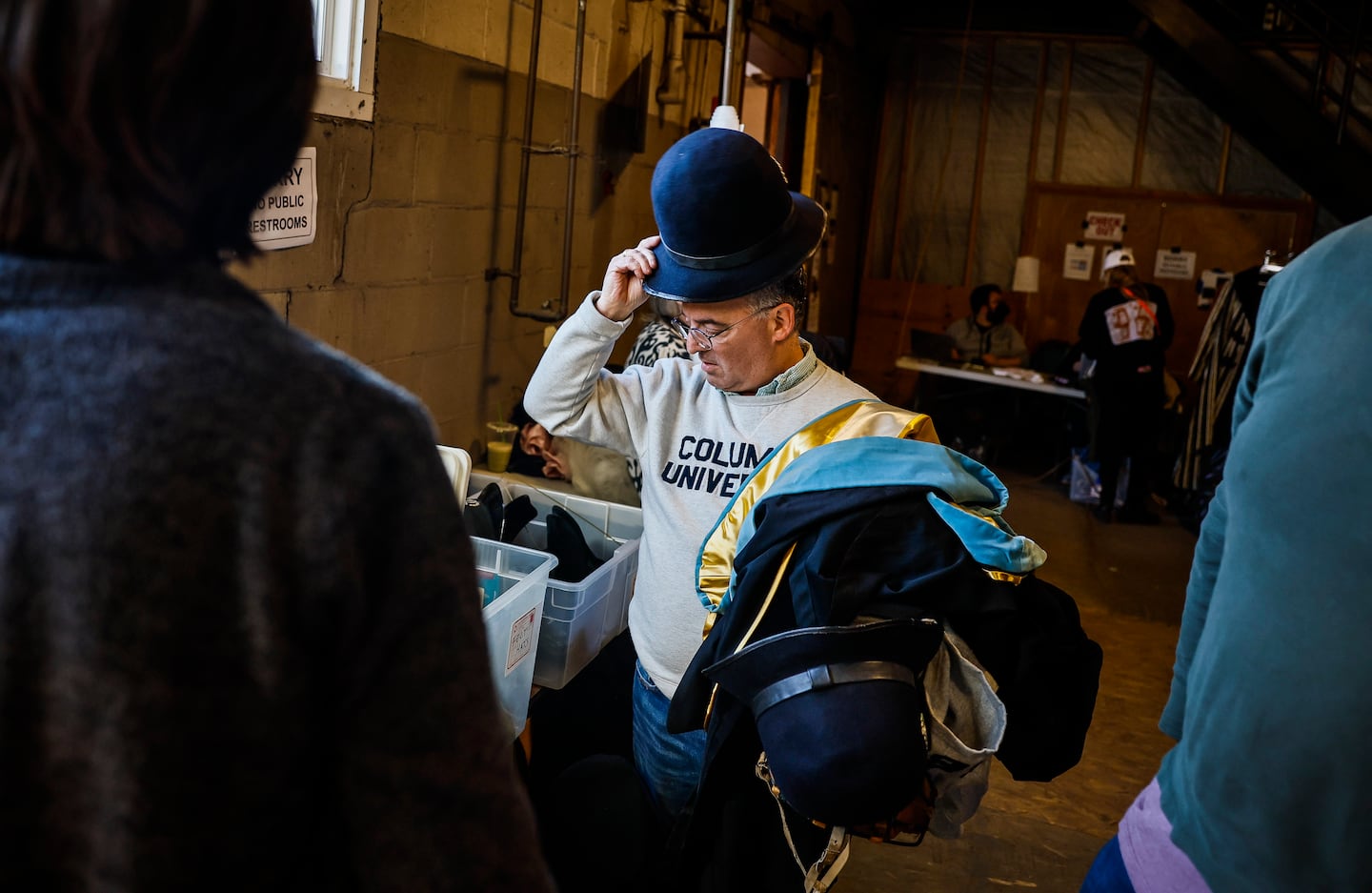 People browse a hat collection at the American Repertory Theater's costume shop sale Friday.