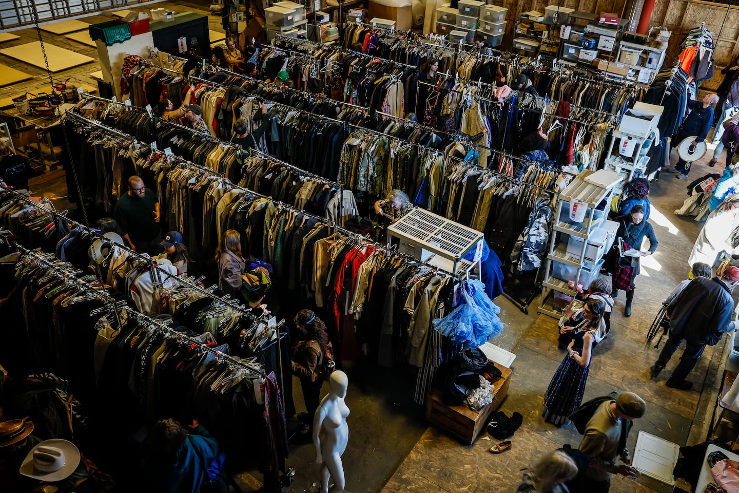 People browse costumes at the American Repertory Theater's costume shop sale Friday.