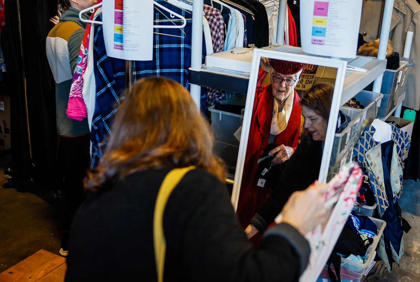 People tried on hats and costumes at the American Repertory Theater's costume shop sale.