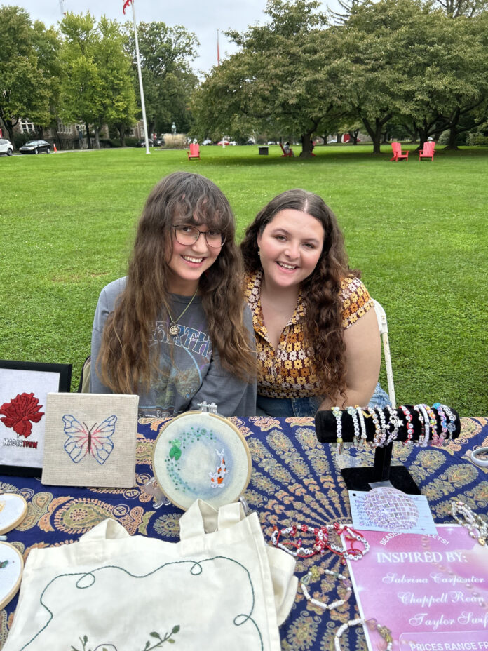 Kayla Bassoff '25 and Carly Langshultz '25 sell their art is the farmer's market. Photo courtesy of Kayla Bassoff '25.