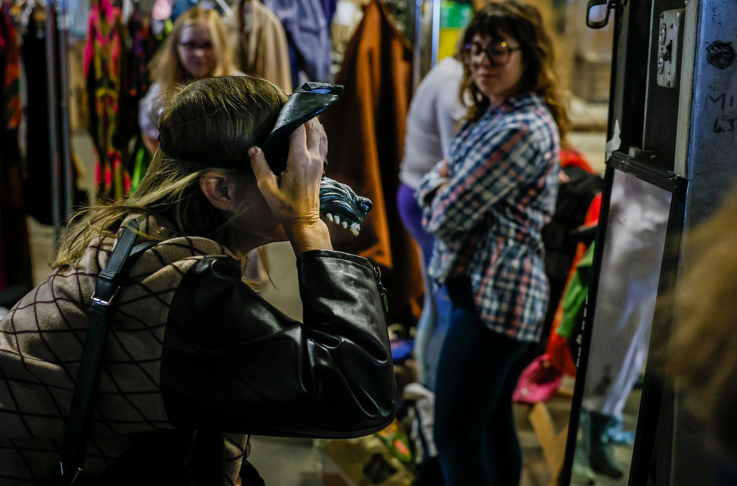 People tried on masks and costumes at the American Repertory Theater's costume shop sale Friday.