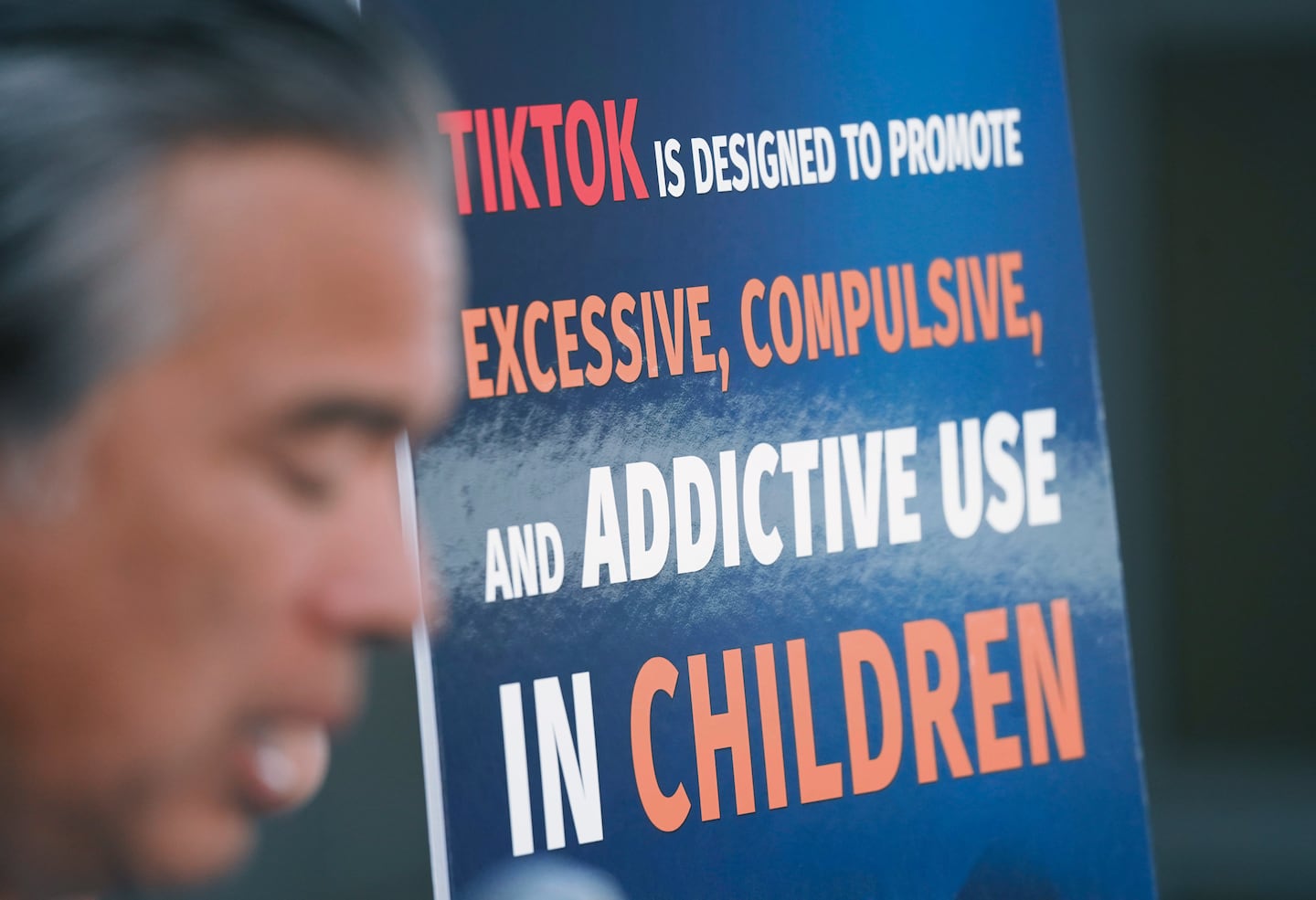 A poster criticizing TikTok was on display on Oct. 8 as California Attorney General Rob Bonta announced that several states were suing the company for allegedly violating consumer-protection laws.