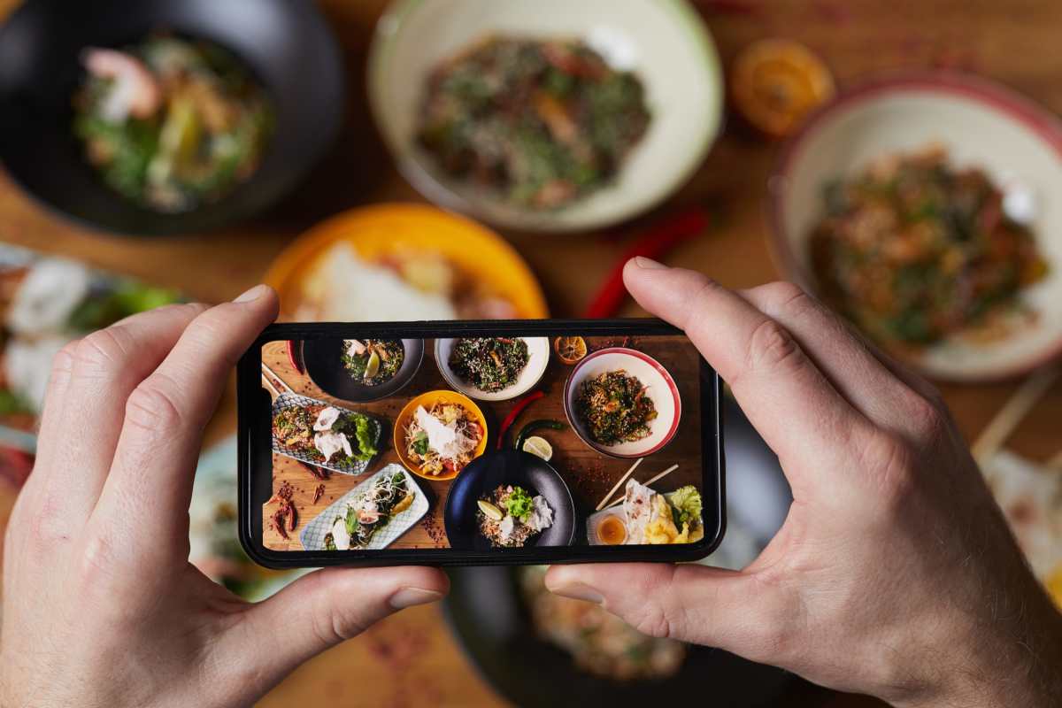 Close up of person taking photo of Asian food - (Image source: Stock photo/Getty Images)