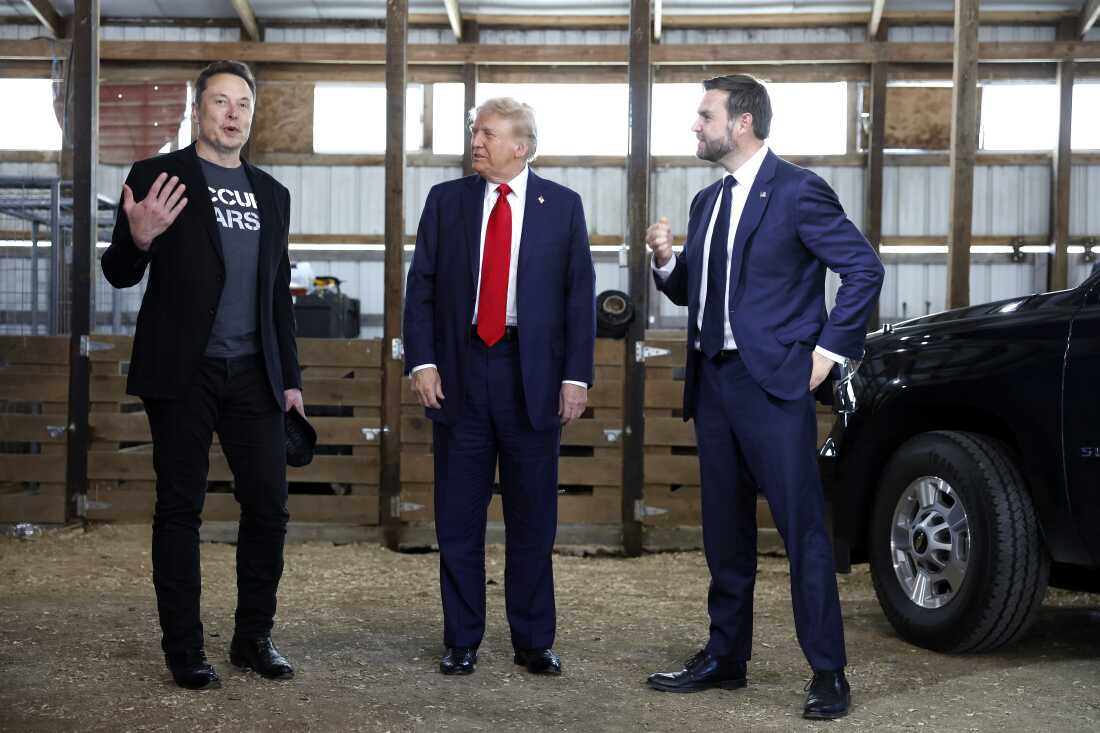 From left to right, Elon Musk, Republican presidential nominee Donald Trump and his running mate Sen. JD Vance talk to reporters back stage during a campaign rally on Oct. 05, 2024 in Butler, Pa.