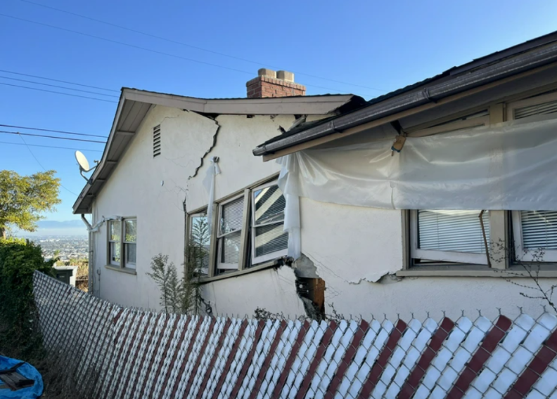 The side of a house where the walls are collapsing.