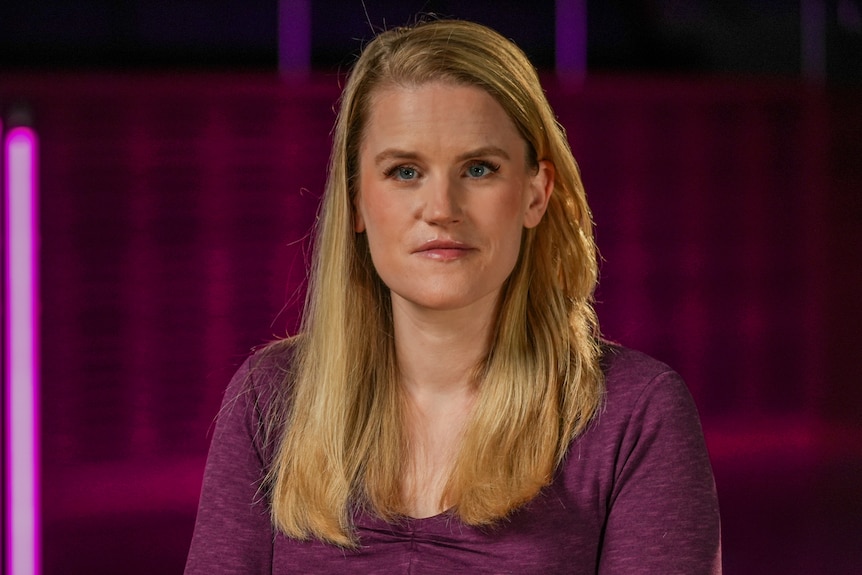 Frances Haugen portrait looks down the barrel of the camera 