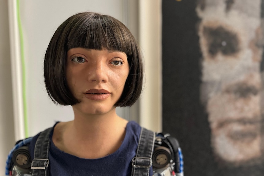 a human-like female robot with a bob in front of a blotchy surreal portrait of a man