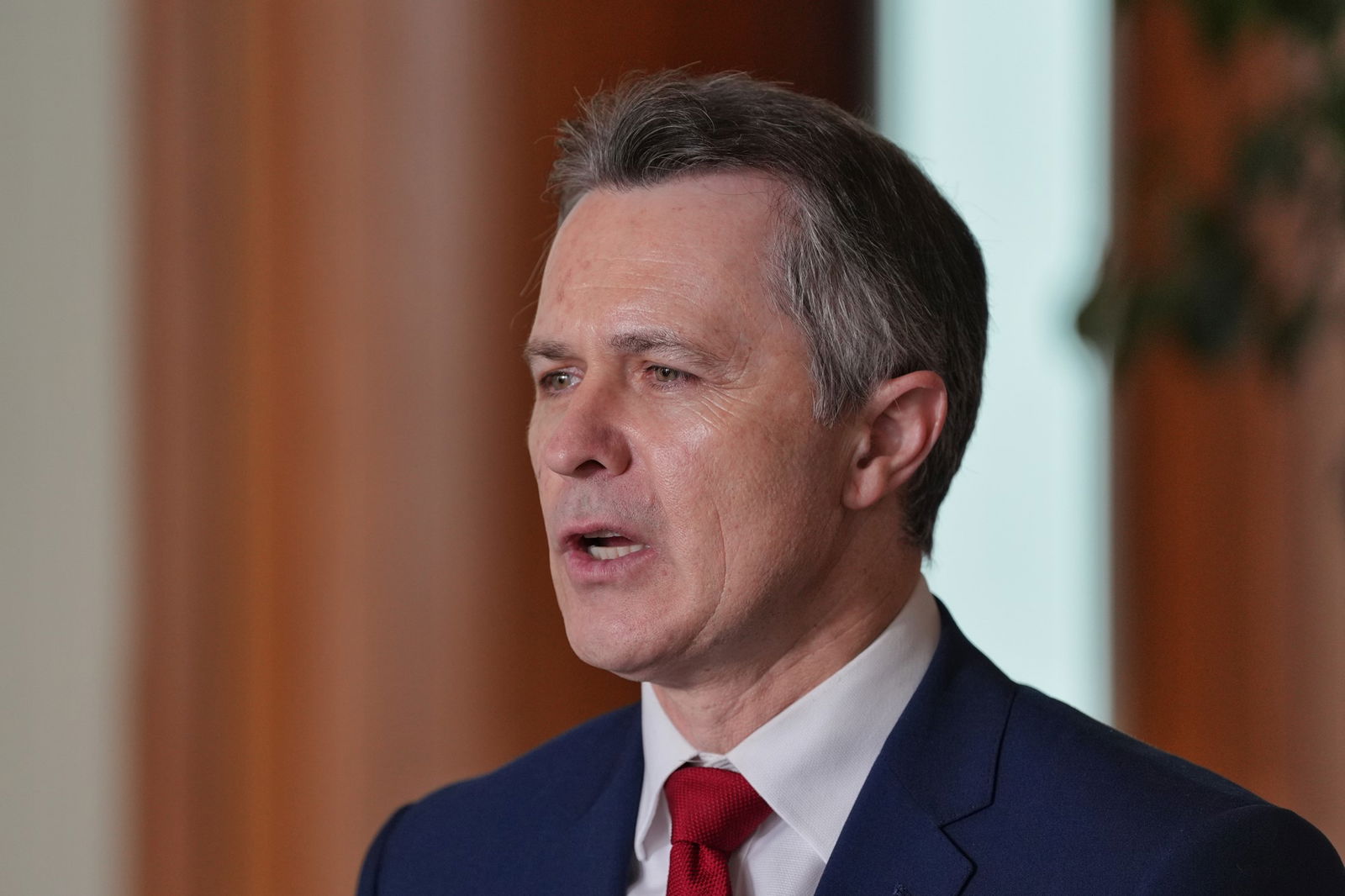 A close up of a man with a red tie