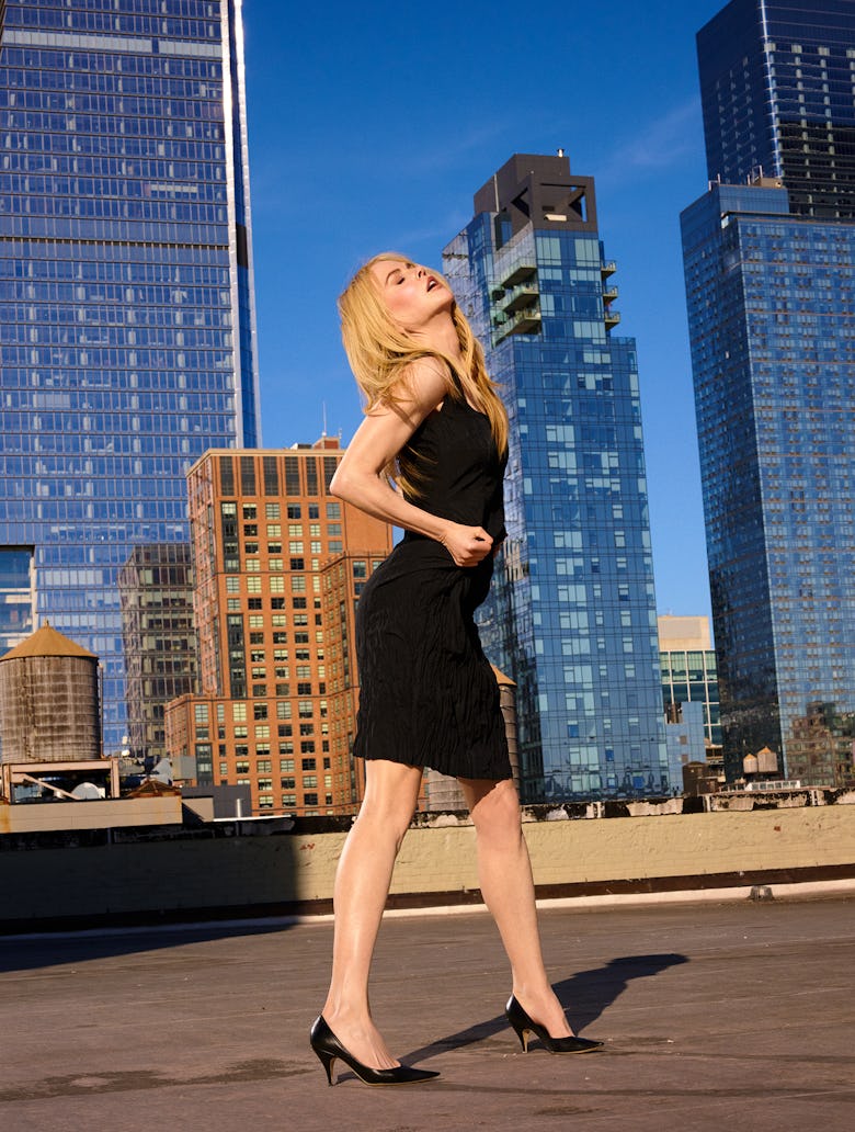 Nicole Kidman wearing a black dress, and black shoes.