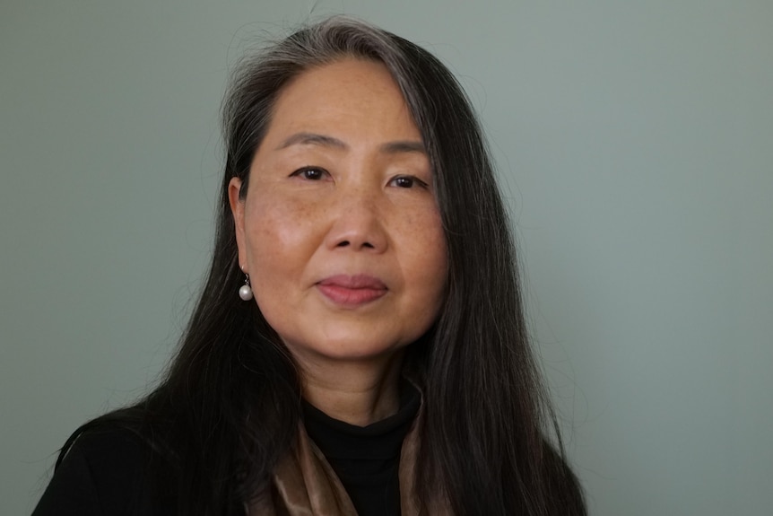 A close of a woman on a grey background