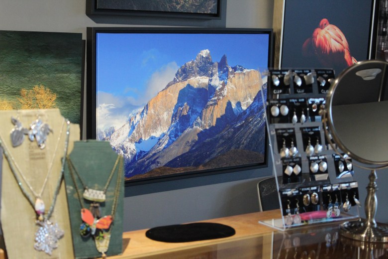 One of Steve Sorensen's photographs, center, is framed between jewelry pieces Dec. 3 at the Foothills Art Center's 49th annual Holiday Art Market at its Astor House campus