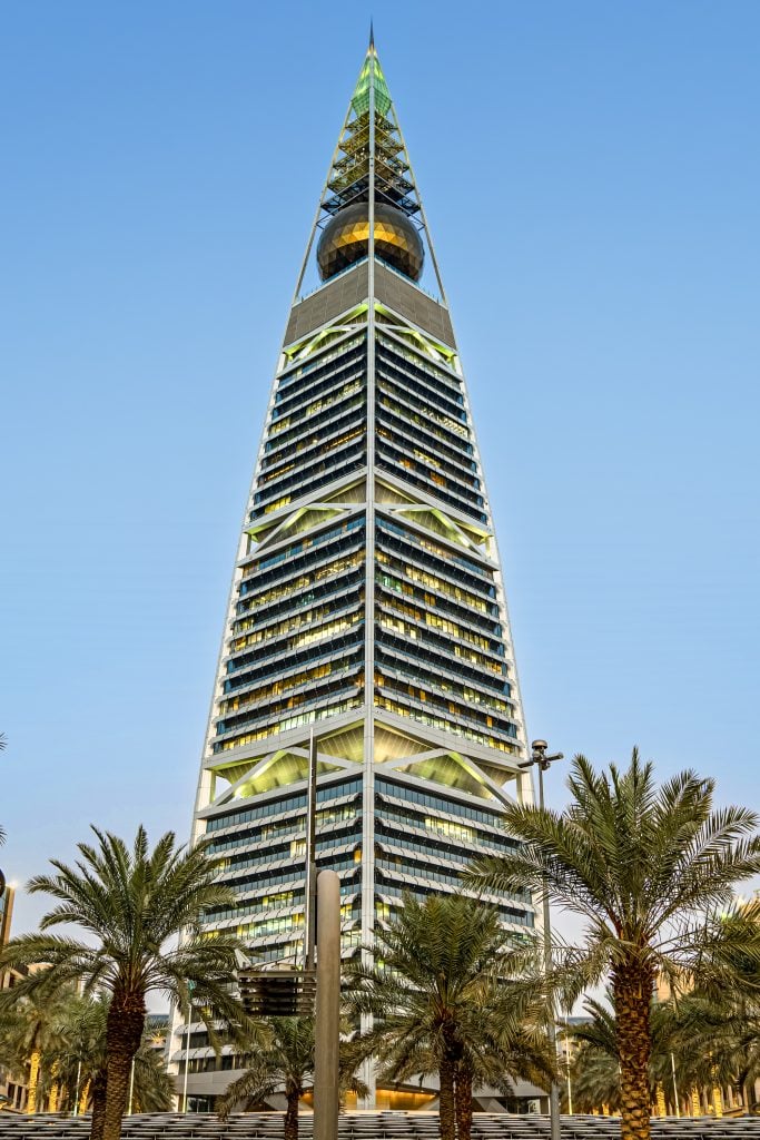 an image of the Al Faisaliyah Center Tower surrounded by Palm Trees