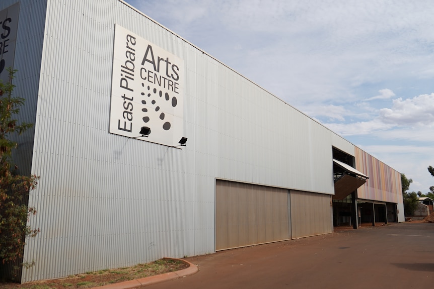 A large steel building with a sign in its top left which reads: 'East Pilbara Arts Centre'