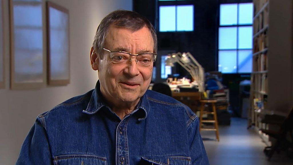 American painter Robert Ryman wearing glasses and a denim shirt