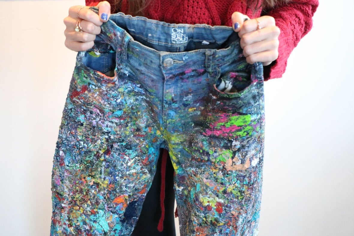 A pair of jeans covered in dried paint