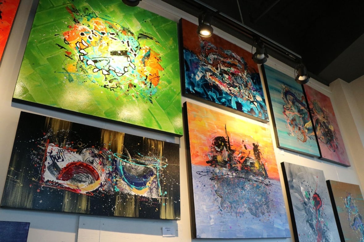 Paintings displayed on a wall. 