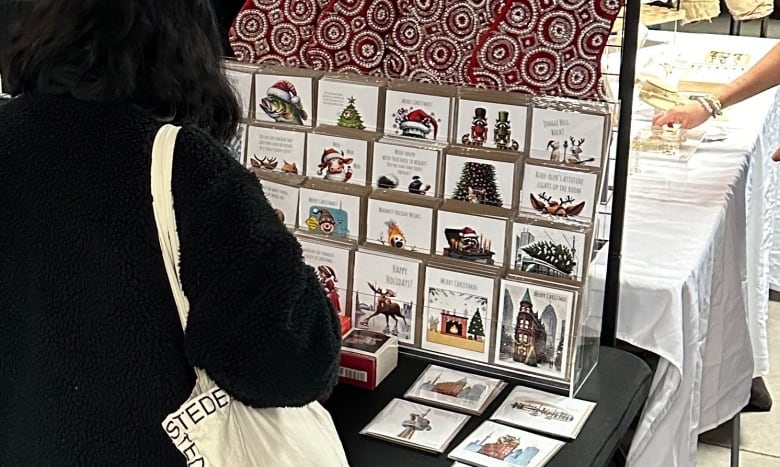 A customer views the display of greeting cards