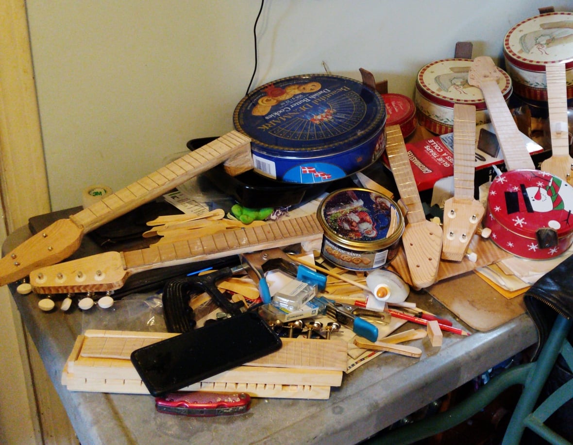 A pile of banjos made using cookie tins.