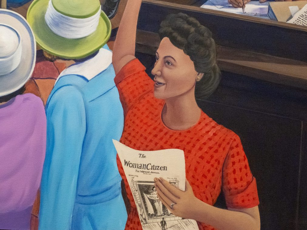 Phyllis Garibay-Coon embraces two of her sisters, Nicki Harders and Jennifer Vulgamore, after the unveiling of her work 