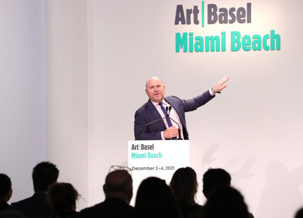 Image of a man speaking on a stage.