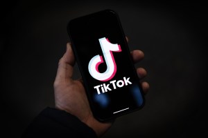 LONDON, ENGLAND - FEBRUARY 28: In this photo illustration, a TikTok logo is displayed on an iPhone on February 28, 2023 in London, England. This week, the US government and European Union's parliament have announced bans on installing the popular social media app on staff devices. (Photo by Dan Kitwood/Getty Images)