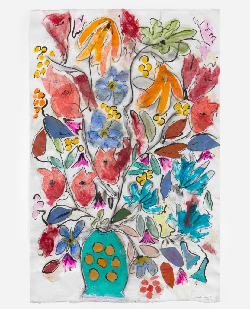 a composition of a vase filled with very colorful flowers