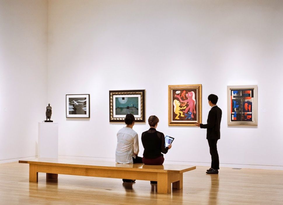 Three young men in a museum