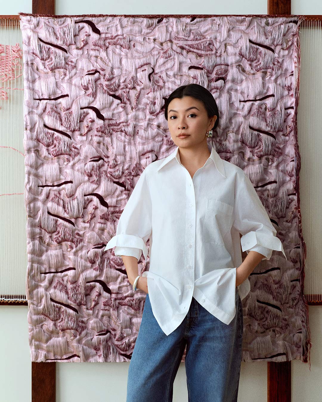 Artist Amber Chen with the textile artwork she created for her collaboration with COS