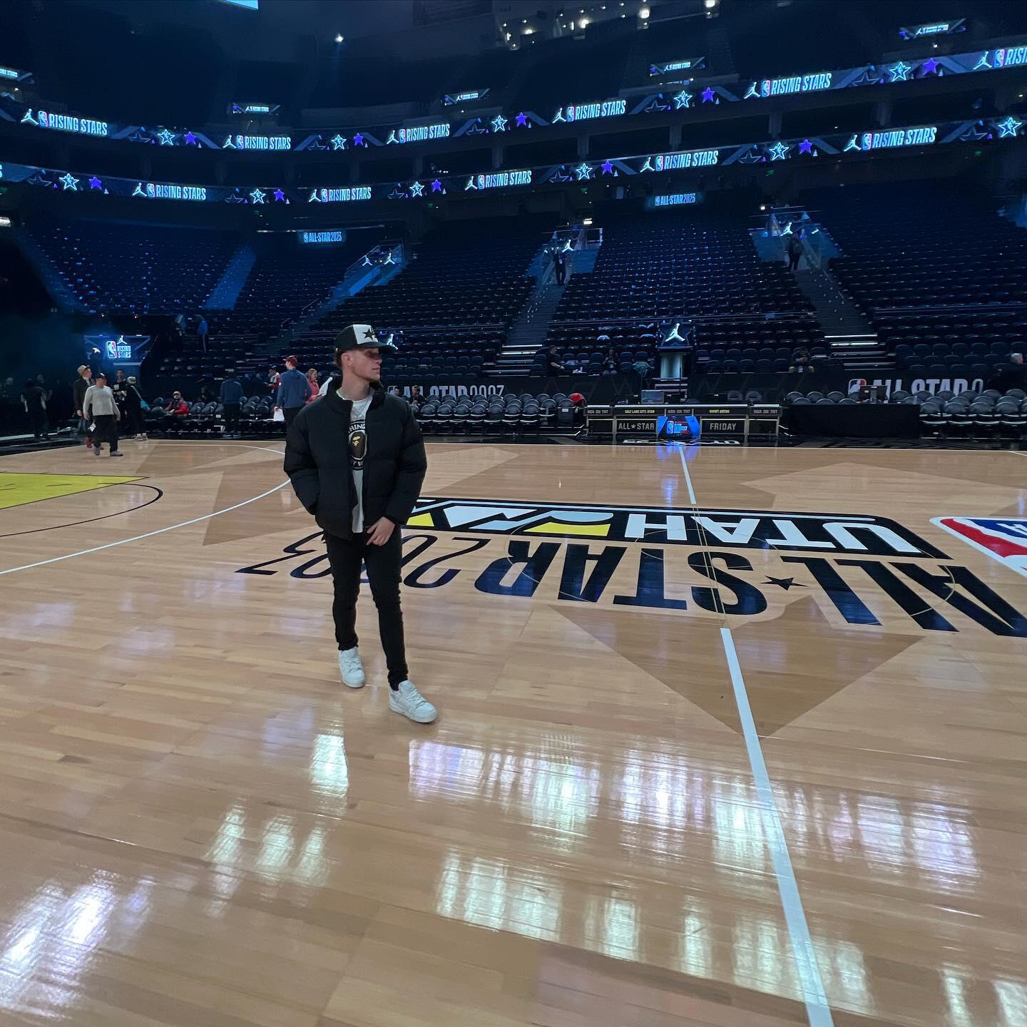 A photo of a man walking on a basketball court. 