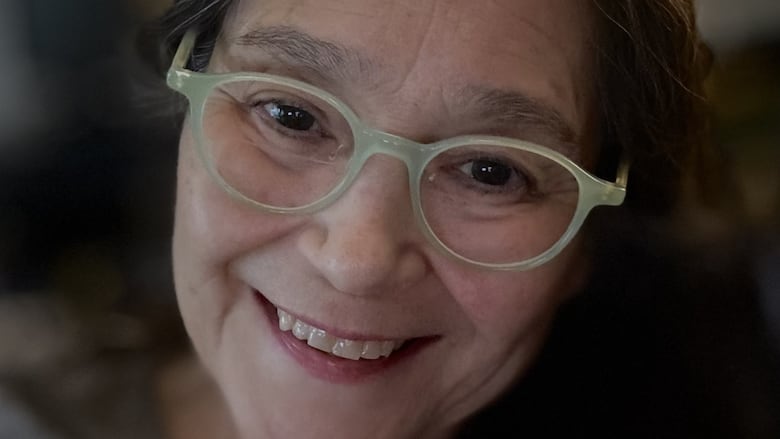 Selfie of a smiling woman wearing glasses.
