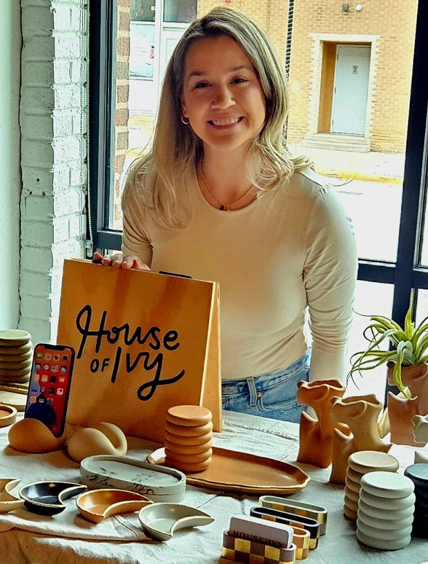 Aurora artist Chelsie Kliese, owner of House of Ivy, sells her art objects made out of concrete at a recent indoor market at Society 57 in downtown Aurora. (David Sharos / For The Beacon-News)