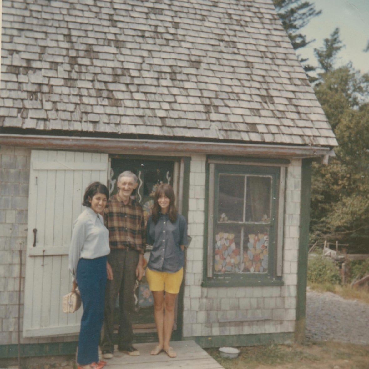 Two women and a man are shown in a 1969 photo taken in front of the home of famed Nova Scotia artist Maud Lewis.