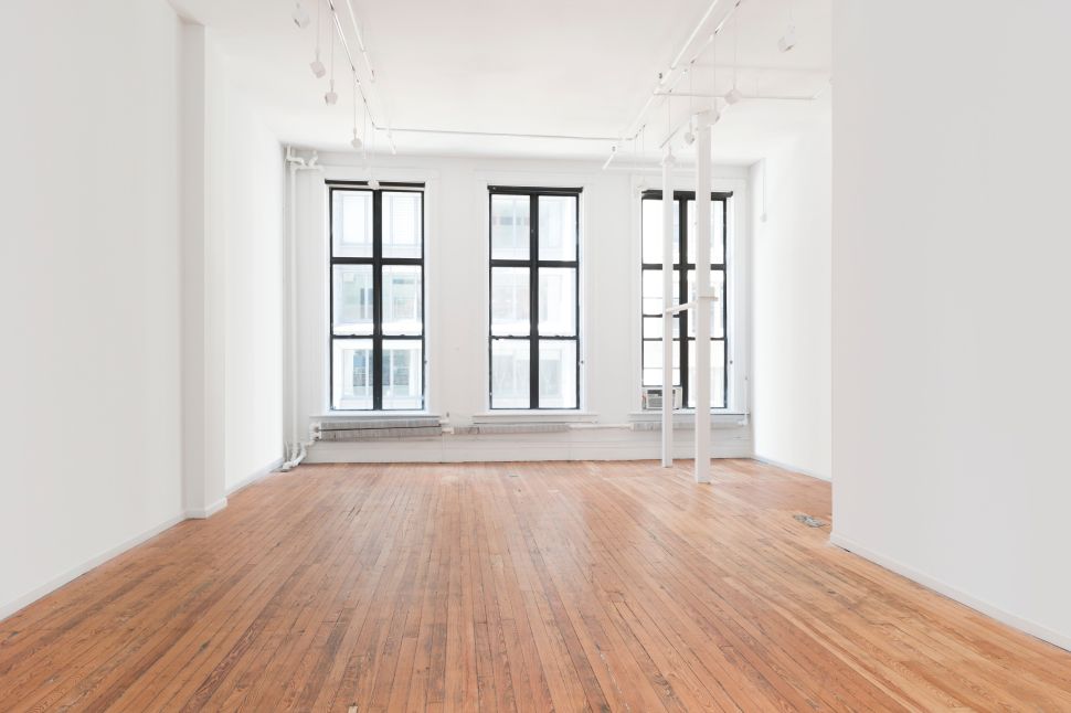 Image of a white wall space with wood floors