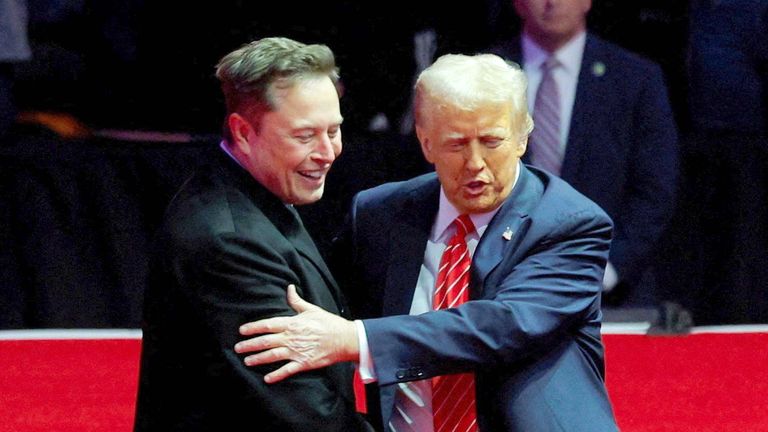 Donald Trump greets Tesla CEO and X owner Elon Musk during a rally on 19 January. Pic: Reuters