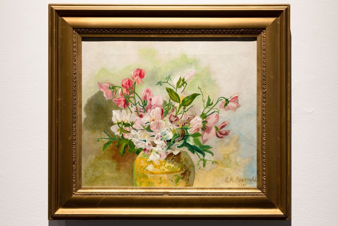 An oil painting of sweet peas in a vase.