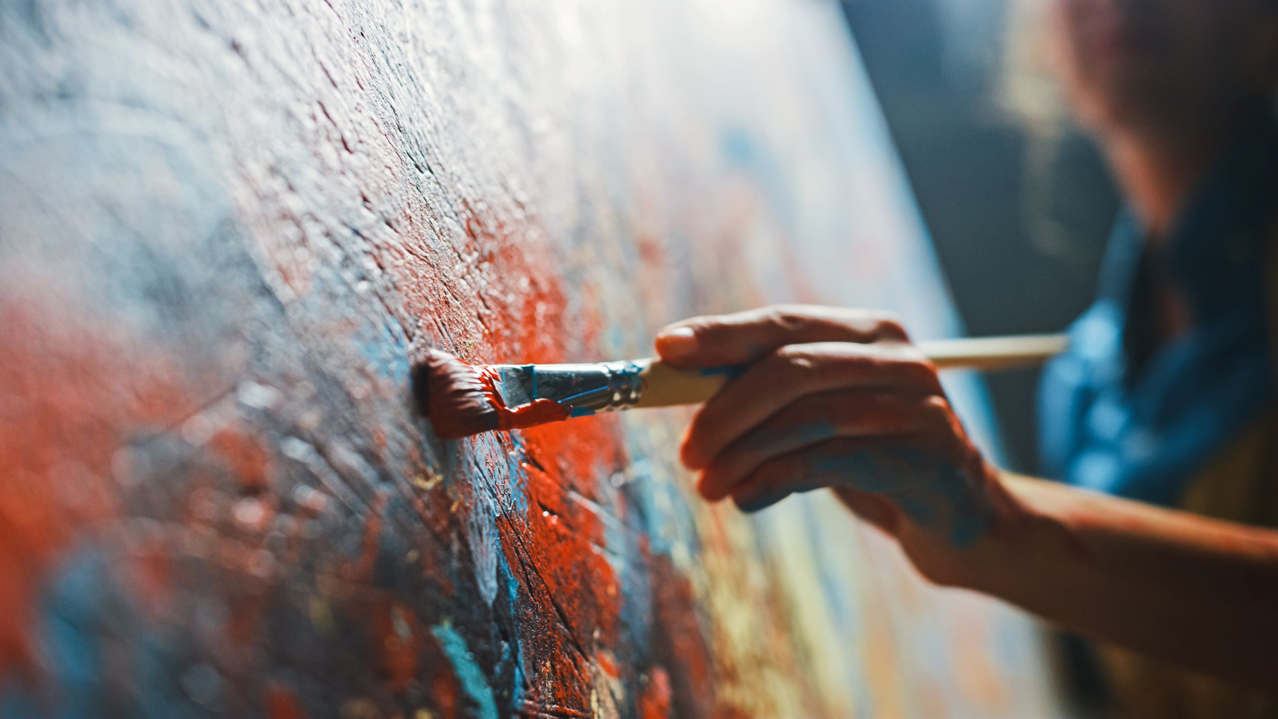 hand holding a paint brush painting a picture