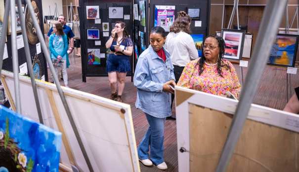 More than 100 artists, their guests and Med Center employees attended the kickoff reception of the 33rd Annual Med Center Health’s Women in the Arts Exhibit Thursday, March 13, 2025 at the The Medical Center-WKU Health Sciences Complex. Winners were announced and awards were handed out during the event. The art exhibit is scheduled for Friday, March 14 and Saturday, March 15 at The Medical Center-WKU Health Sciences Complex. According to Med Center Health, the event provides female artists with an opportunity to showcase their work. The exhibit is open to any female artist over 18 years old residing in Kentucky. Artists may enter their artwork in the following categories: painting, sculpture, ceramics, works on paper, fiber works and photography. Awards include Special Purchase, Cash Merit, Honorable Mention, and ArtWorks Award. The exhibition committee and a juror will select the 2025 Special Purchase Award piece which will be purchased by and displayed at The Medical Center. (Daily News photo by Joe Imel)