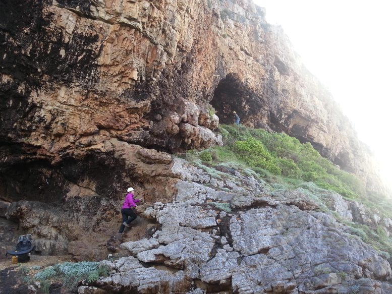 Archaeologist Climbing up the Cliffside to the Cave Site