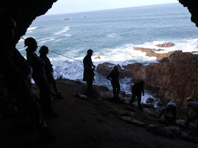 Archaeologists Working in the Cave Overlooking the Ocean