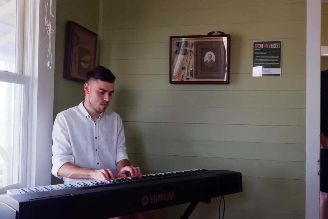Ukrainian composer and pianist Alex Syedin performs at the “Many Faces, One Force” exhibit. Syedin came to the U.S. as a refugee in 2022 after Russia invaded Ukraine.