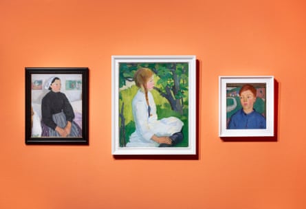 Three portrait works hung on an orange wall