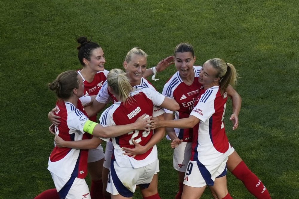 Arsenal's Stina Blackstenius, third from right, celebrates with her teammates after scoring her side's opening goal during the women's Champions League final soccer match between Arsenal and FC Barcelona at the Jose Alvalade Stadium in Lisbon, Saturday, May 24, 2025. (AP Photo/Ana Brigida)