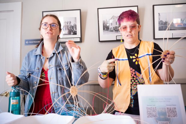 Visitors learn basket weaving techniques from artist Salix Renan at...
