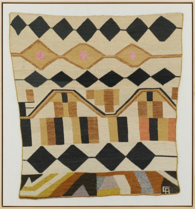 A weaving composed of rows of black triangles, beige striping, and more.
